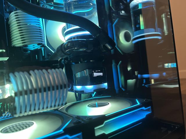 Over the GPU block toward the pump top and the white cables
